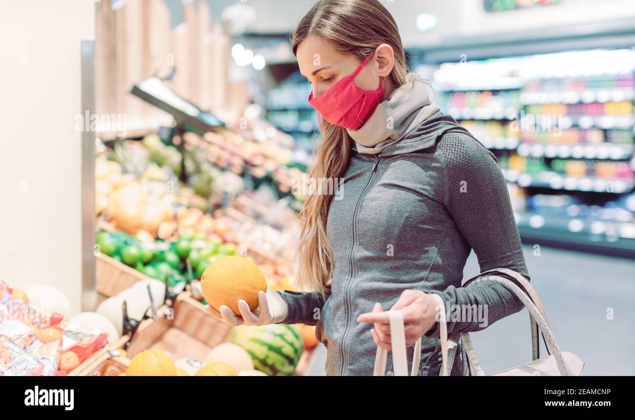 Woman shopping in supermarket during coronavirus lockdown Stock Photo
