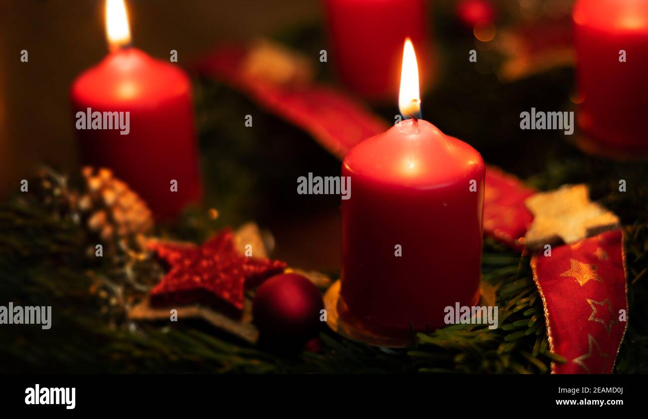 red candles burn with candlelight on an advent wreath Stock Photo Alamy