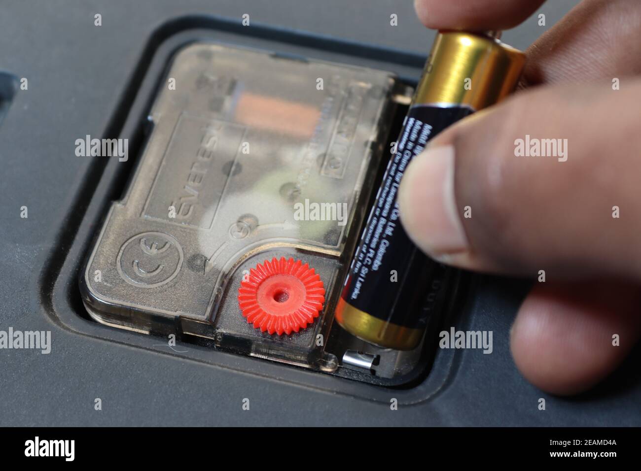 This is very easy domestic activity. Doing our tasks ourselves at home, the moment is showing that replacing a new battery of a wall clock. Stock Photo