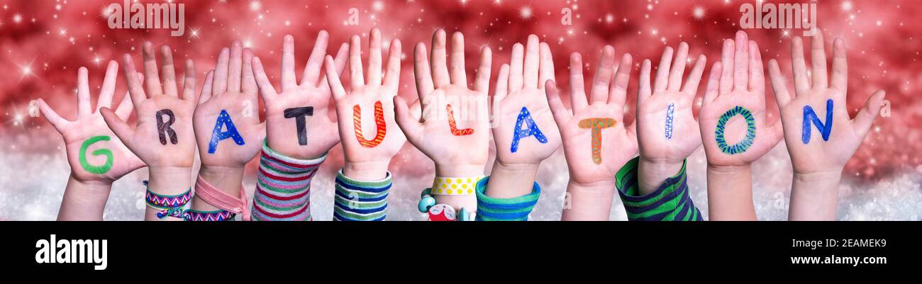Children Hands Gratulation Means Congratulations, Red Christmas Background Stock Photo