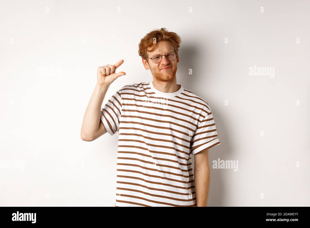 Man Small Resolution Disappointed young man with red hair and beard, wearing glasses and ...