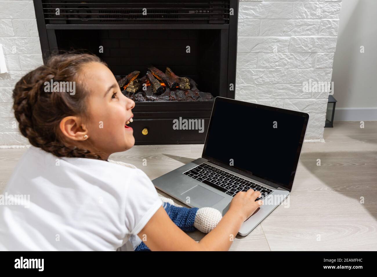 Kids distance learning. Cute little girl using laptop at home ...