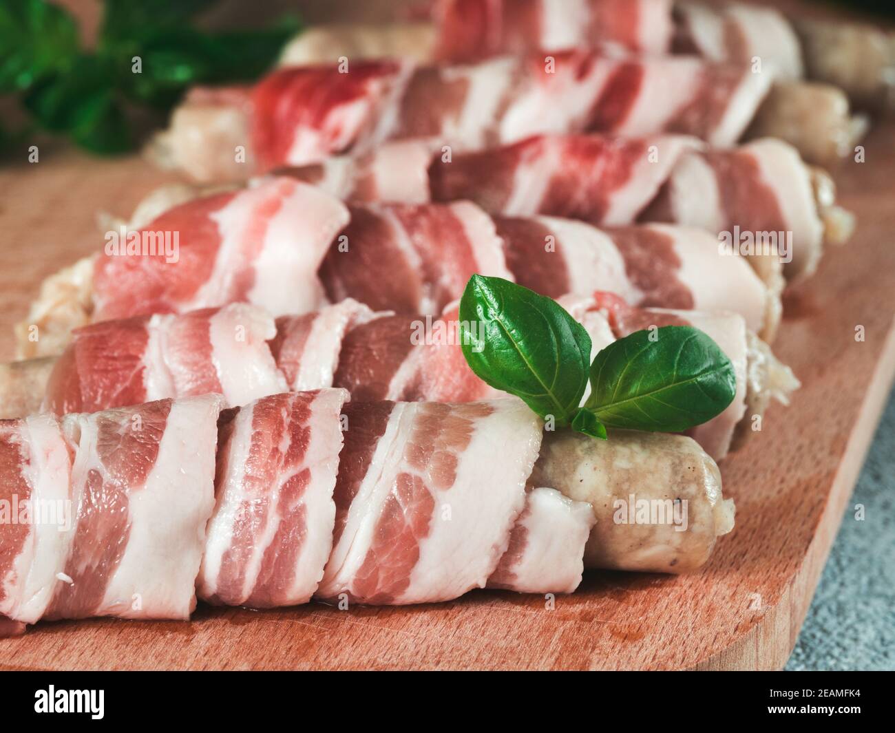 Sausages wrapped in bacon Stock Photo
