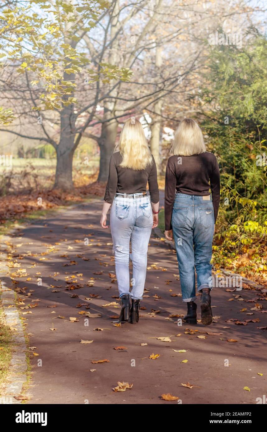 Two girls walking together hi-res stock photography and images - Alamy