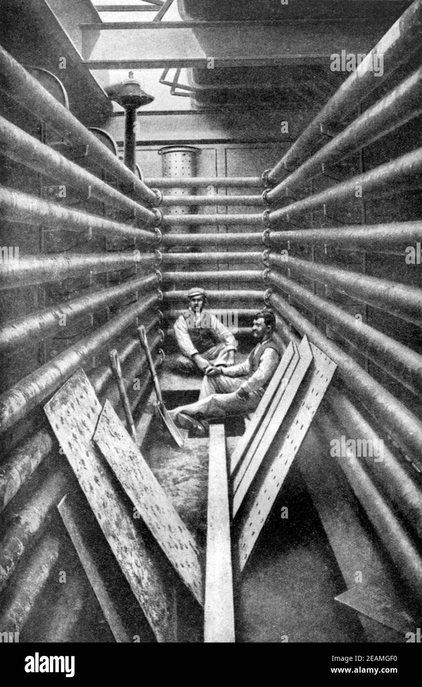 An early 20th century print of Chilean workers in a tank room where caliche mineral deposits were boiled as part of the sodium nitrate mining industry in the Atacama desert Chile South America circa 1920 Stock Photo