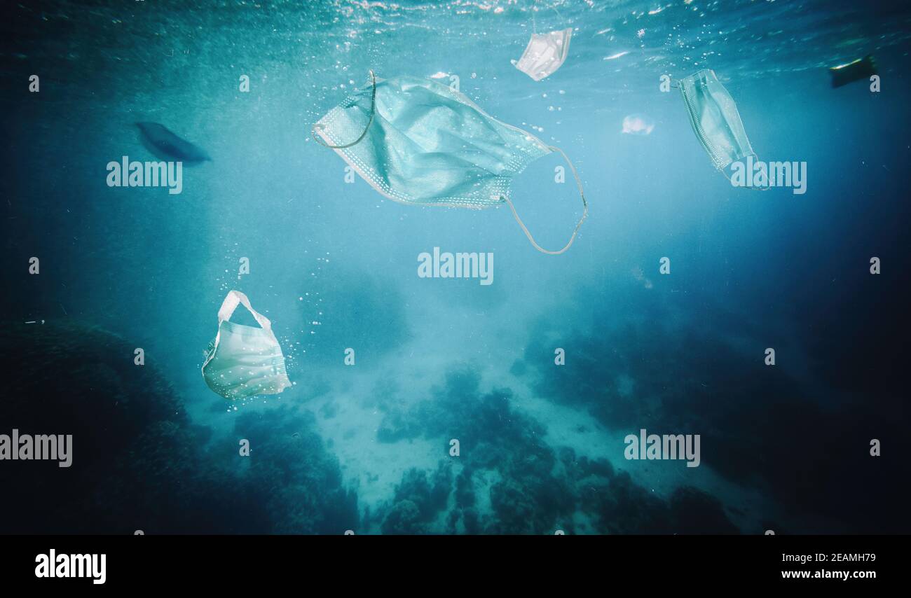 surgical mascheine floating in the sea Stock Photo - Alamy