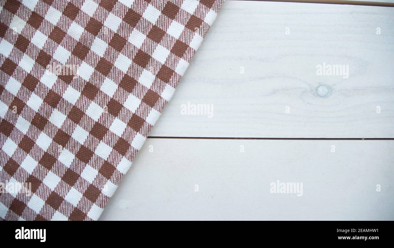 Wooden table covered with tablecloth cloth checkered Stock Photo