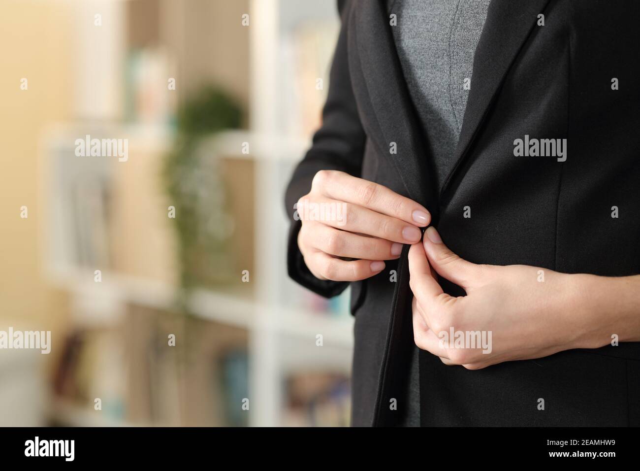 Executive hand fastening button of suit at home Stock Photo