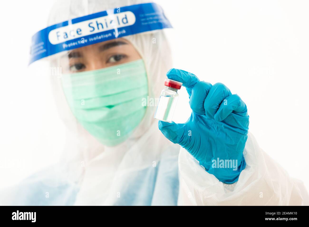 female medical scientist in PPE uniform wearing a face mask protective Stock Photo