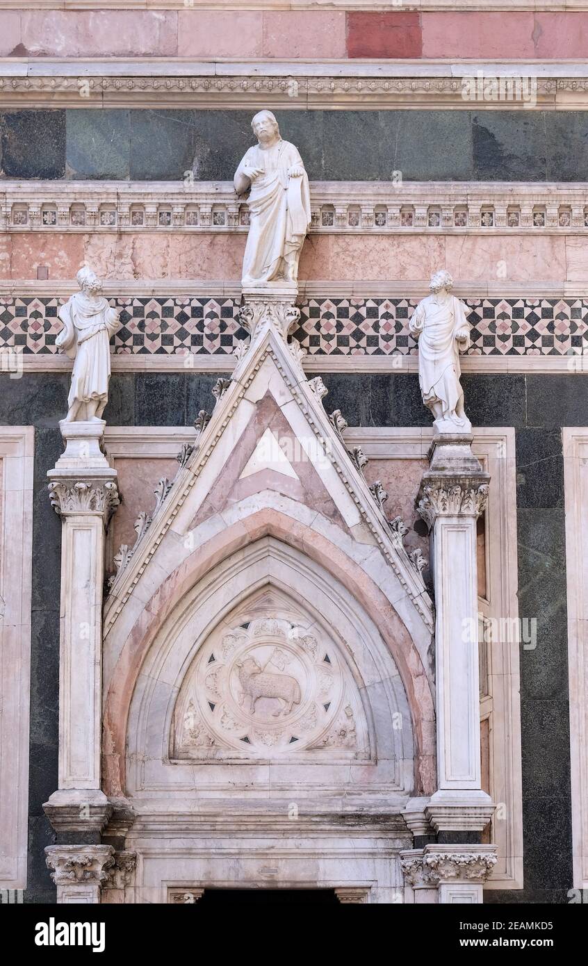 Two Prophets and the Redeemer attributed to Andrea Pisano, Portal on the side-wall of Cattedrale di Santa Maria del Fiore (Cathedral of Saint Mary of the Flower), Florence, Italy Stock Photo