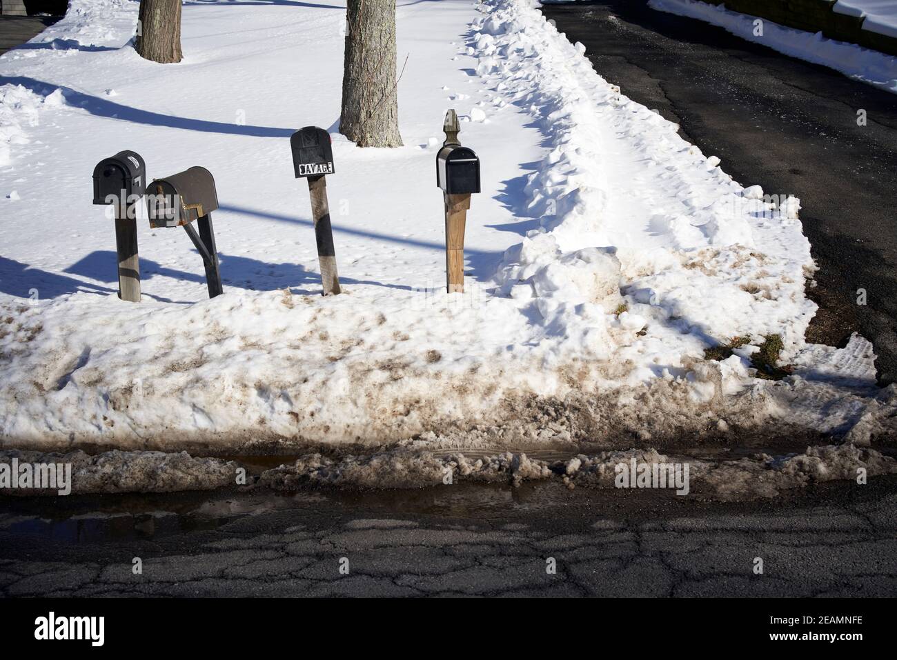 Mailboxes next to snow plowed street in the USA Stock Photo