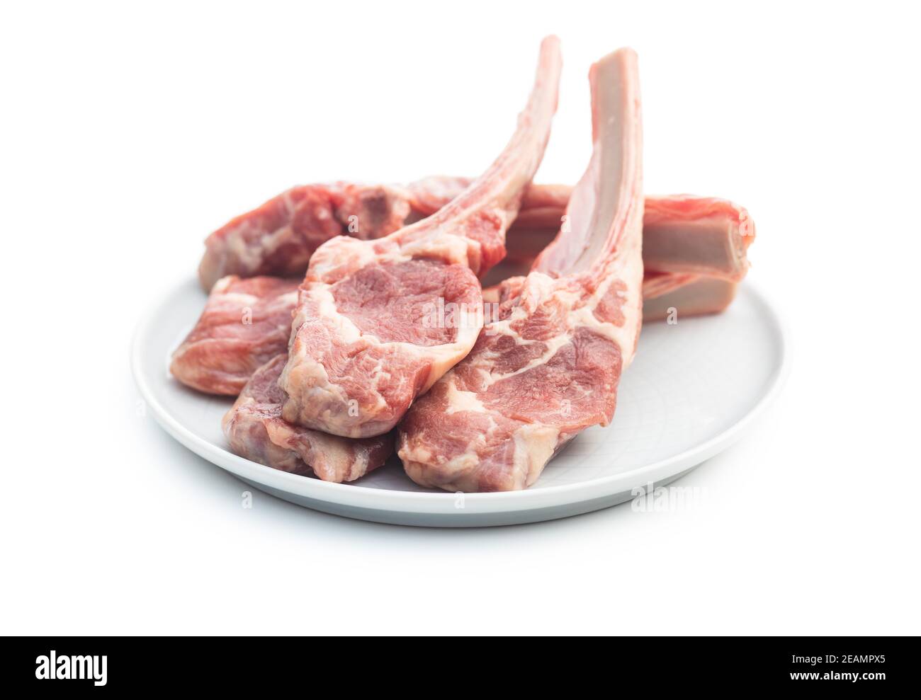 Slices raw lamb chops on plate Stock Photo