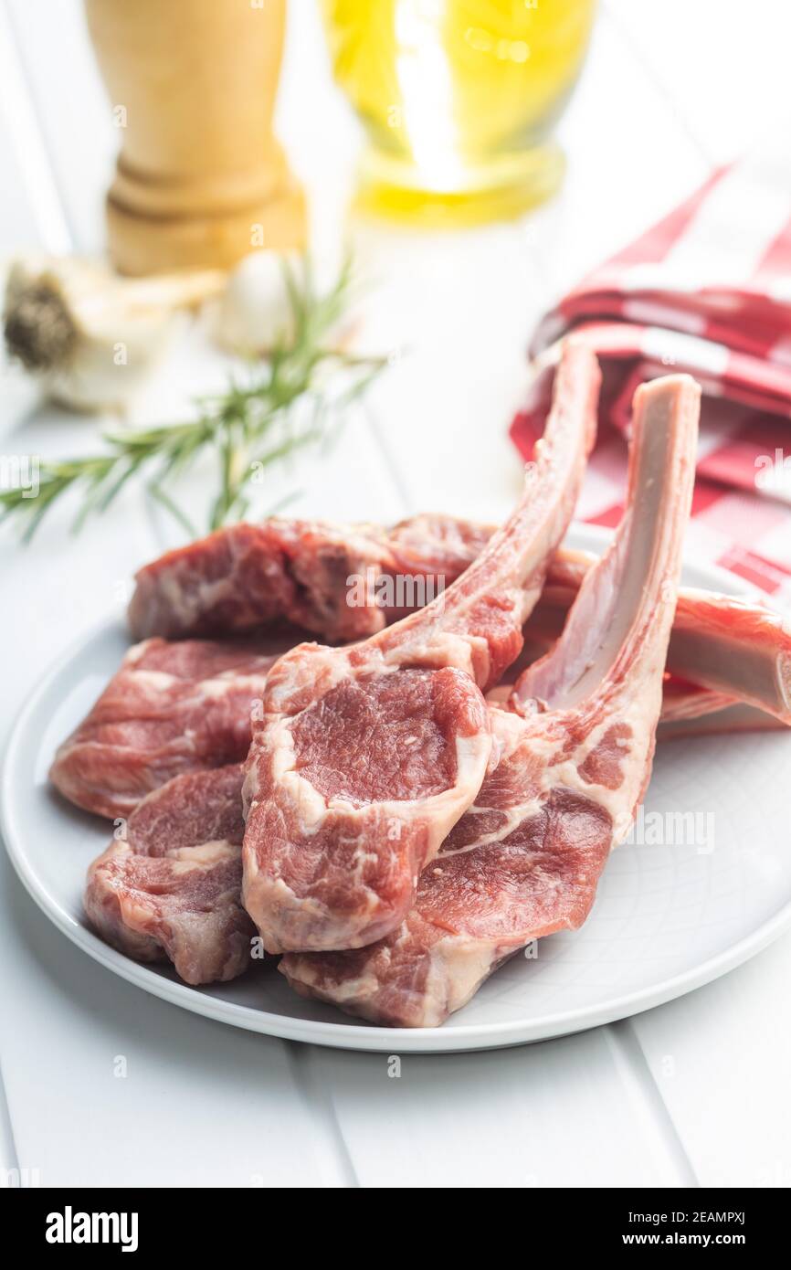 Slices raw lamb chops on plate Stock Photo
