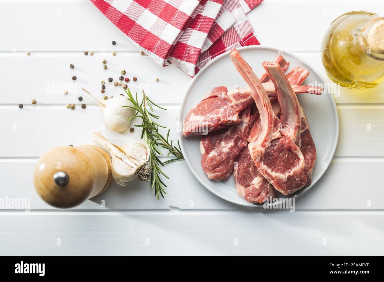 Slices raw lamb chops on plate Stock Photo