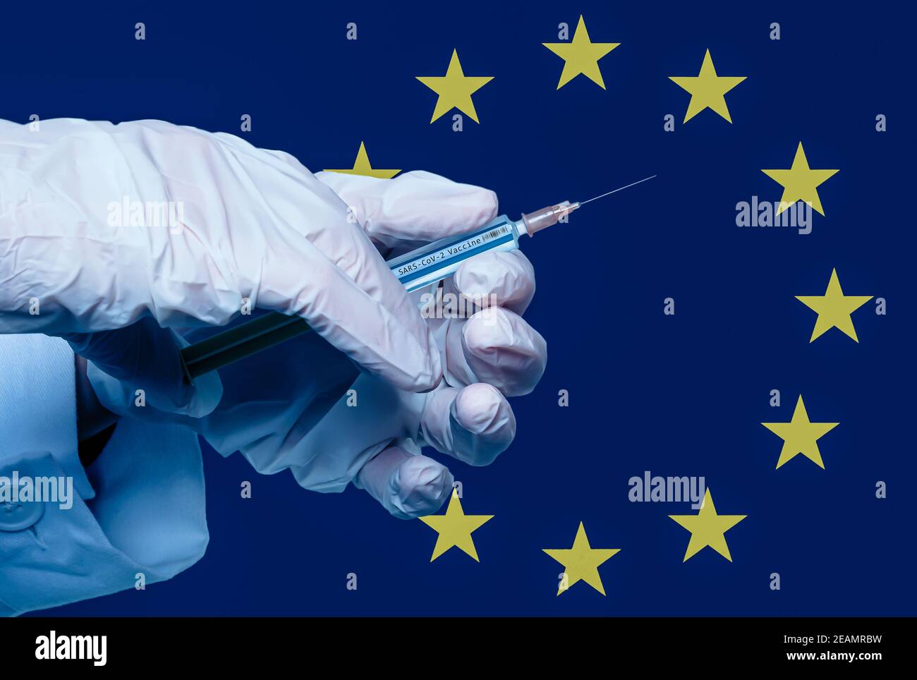 hand with syringe and the inscription sars cov 2 vaccine in front of a european flag Stock Photo