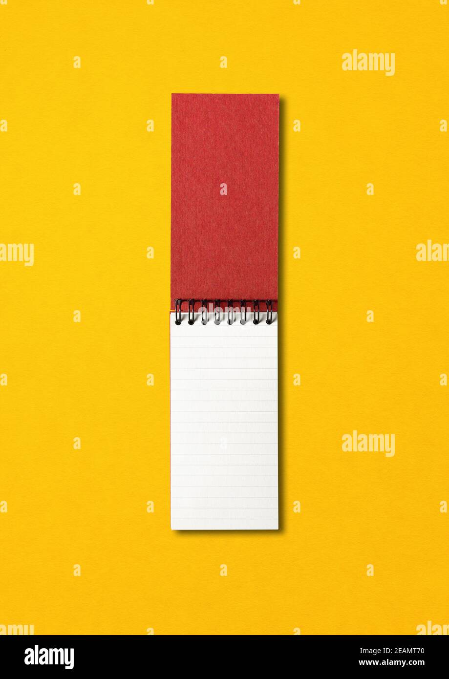 Blank open spiral notebook isolated on yellow Stock Photo