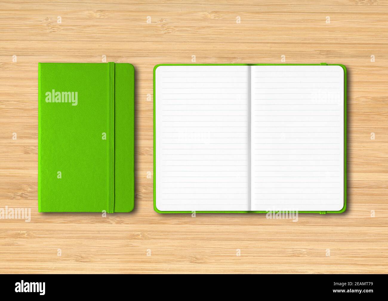 Green closed and open lined notebooks on wooden background Stock Photo