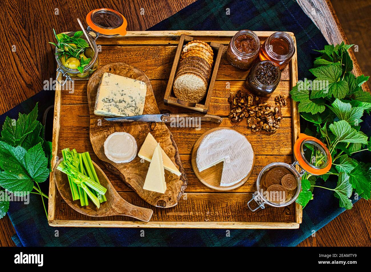 Cheeseboard of fine English cheeses with an assortment of crackers . Stock Photo