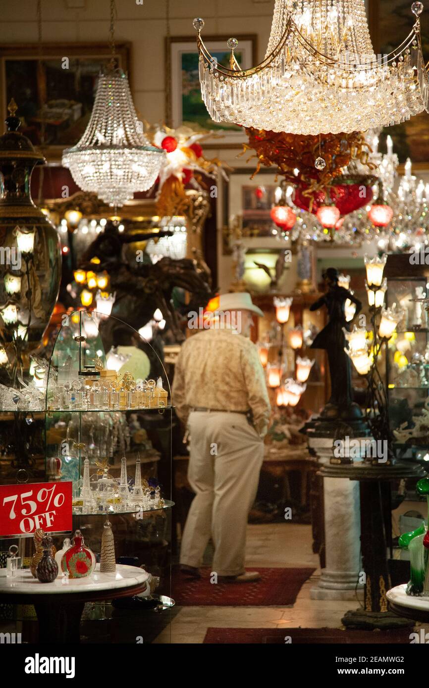 A man with a cowboy hat stands in a lighting and gift store in Las ...