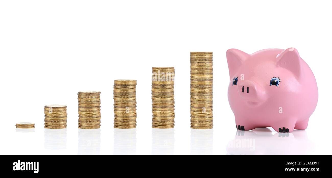 Savings. Investment concept with coins and a peggy bank Stock Photo