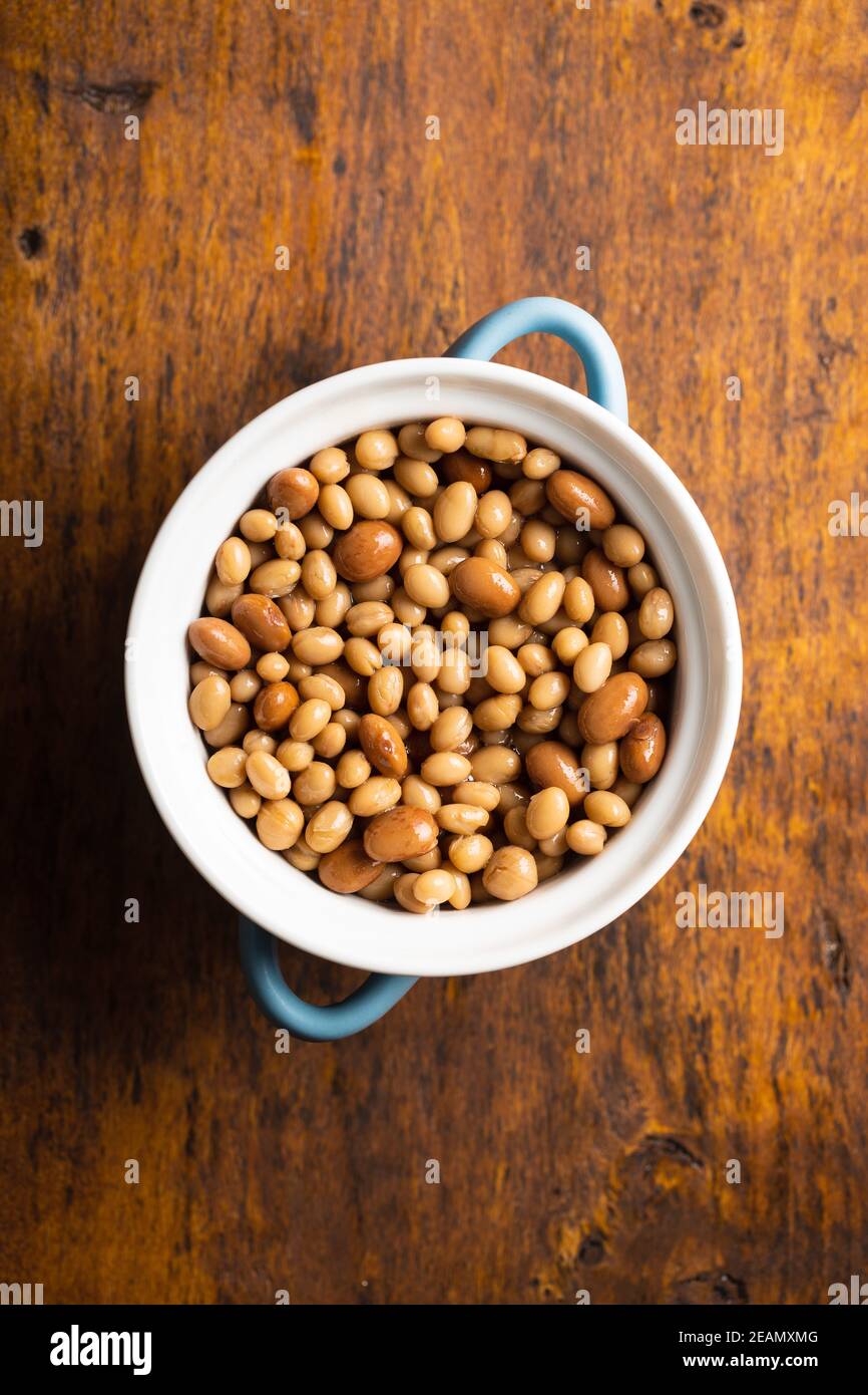 Mix of legume beans and chickpeas with sauce in pot. Stock Photo