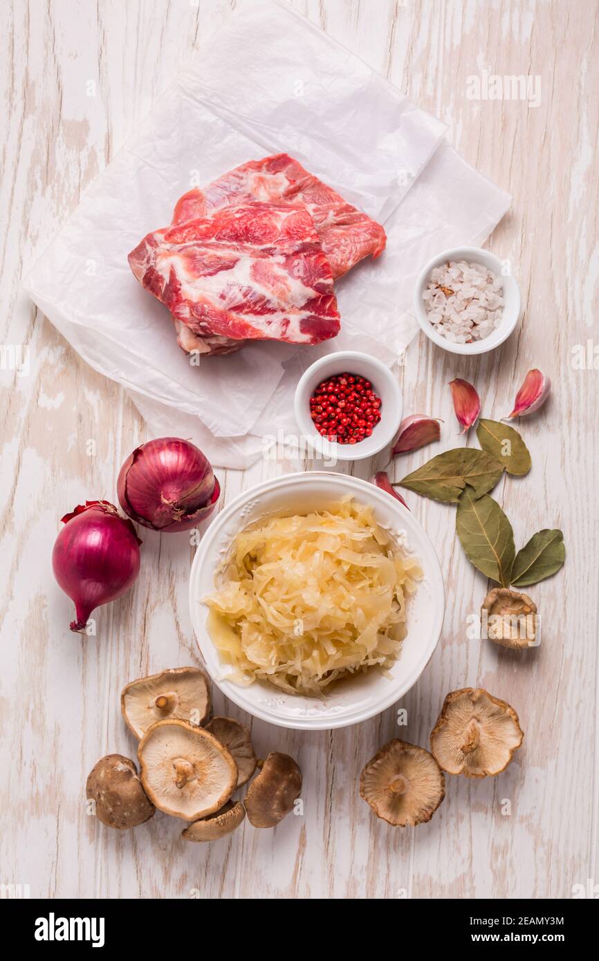 Ingredients for hearty sour cabbage soup (sauerkraut soup) with meat, onioc, garlic and spicies Stock Photo