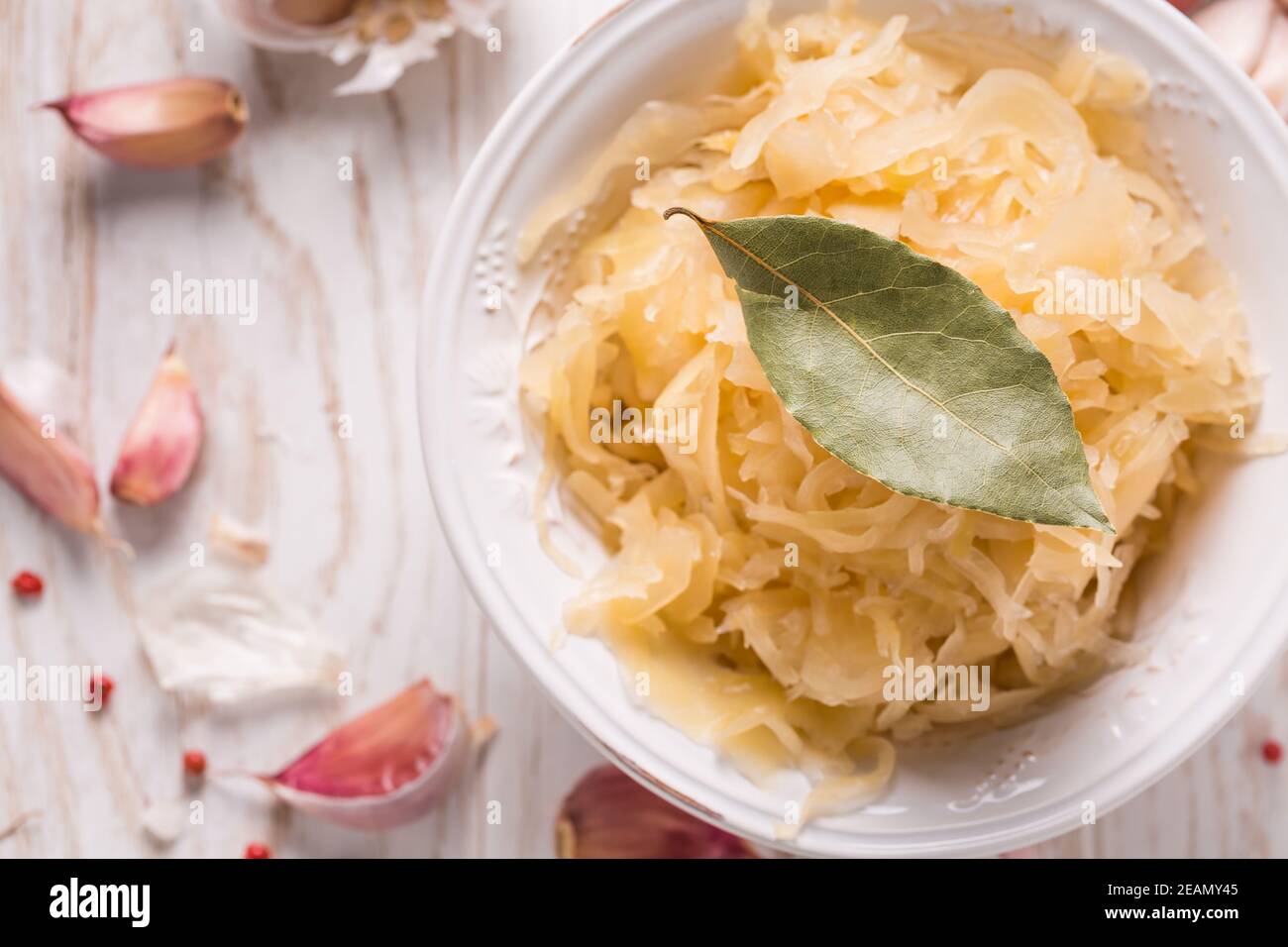 Organic sauerkraut (pickled cabbage) with onions, garlic and spices Stock Photo