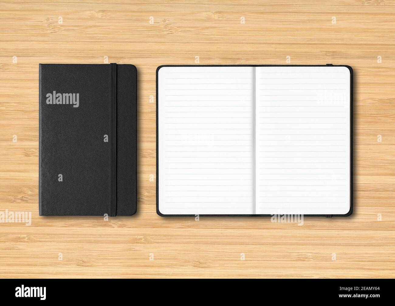 Black closed and open lined notebooks on wooden background Stock Photo