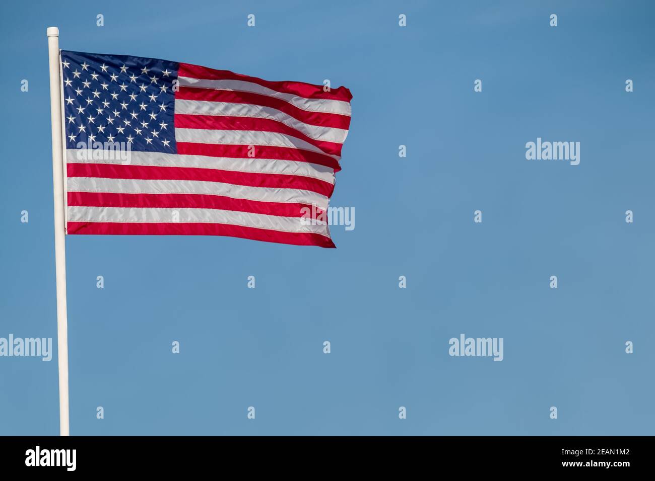 American flag against blue sky copy space Stock Photo - Alamy