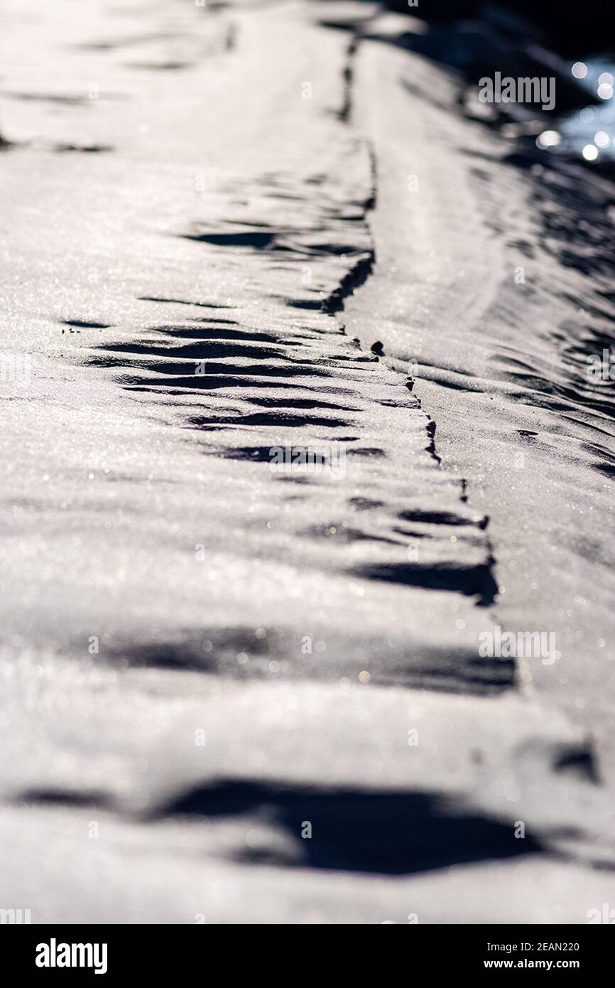 Traces of sole on the sand on the shore of the lake. Stock Photo