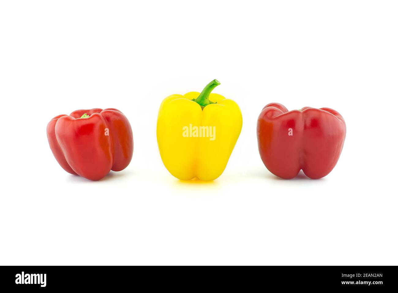 Three red and yellow bell peppers isolated on white background Stock ...
