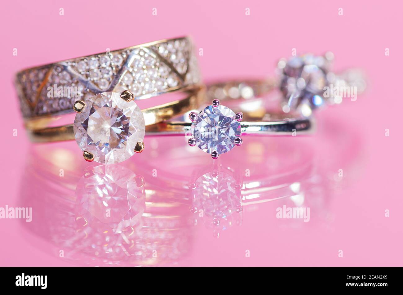 Rings with crystals on a pink background. Stock Photo