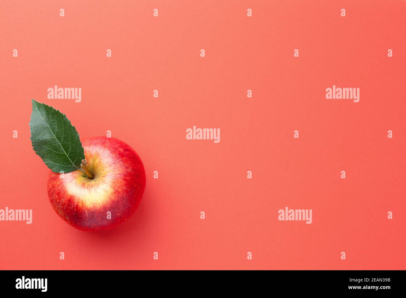 Single Red Apple With Fresh Green Leaf Stock Photo