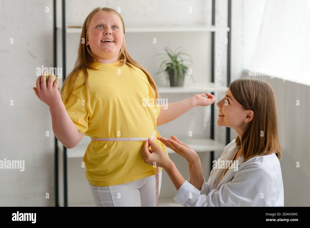 Girl's waist being measured by a nutritionist Stock Photo