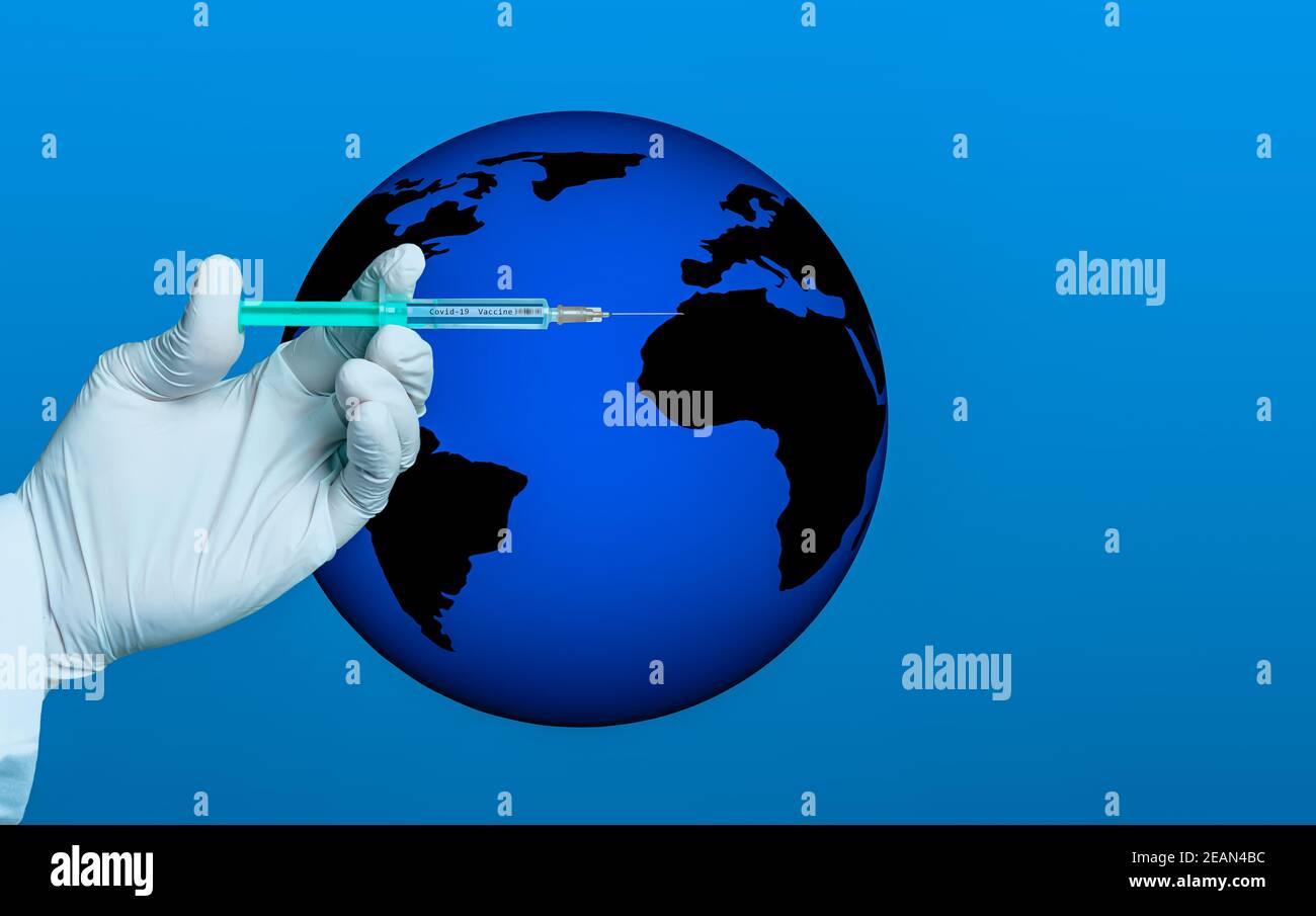 hand with glove holds a syringe with the text covid 19 vaccine Stock Photo