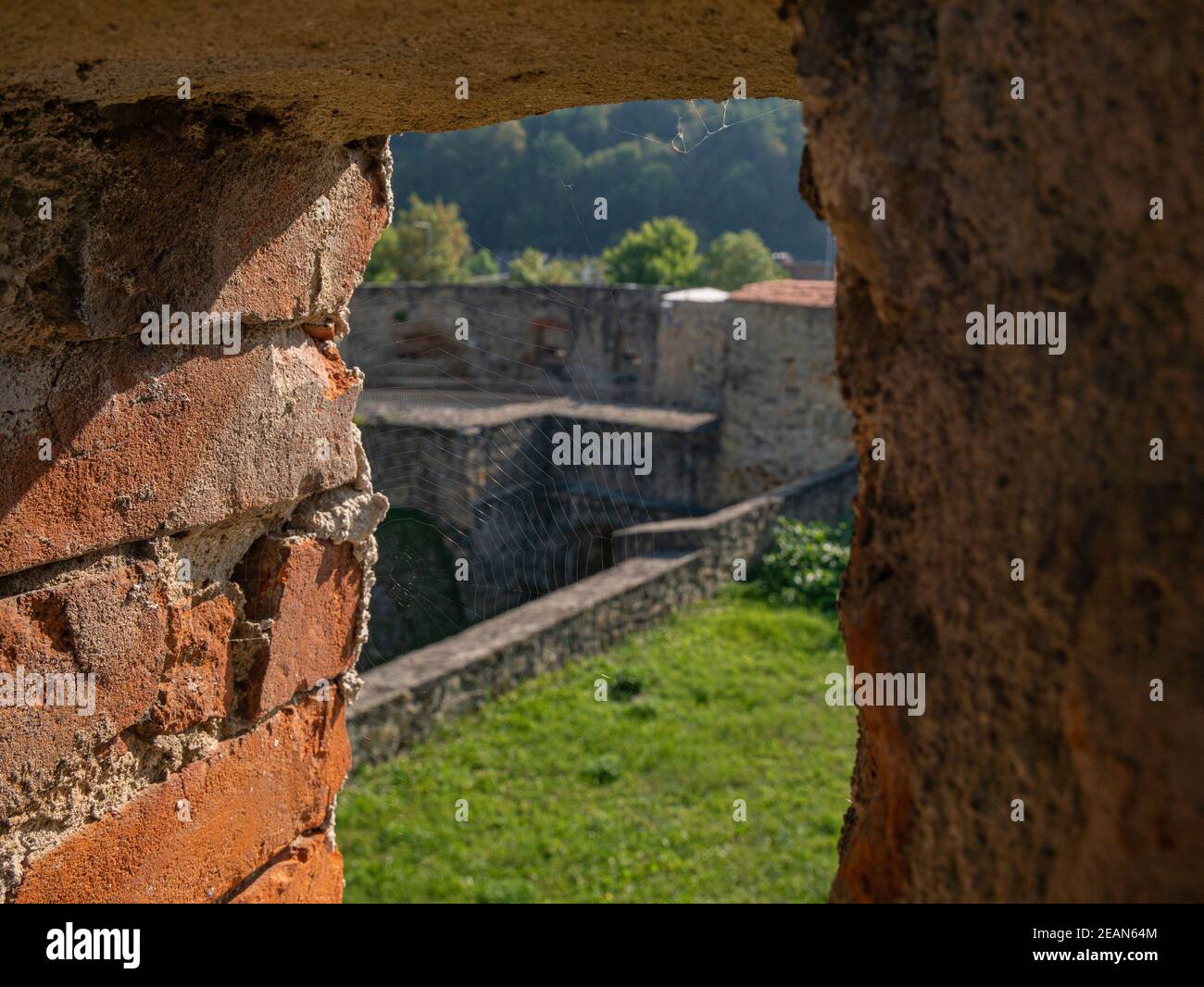 Cobweb in the embrasure of a fortress wall Stock Photo