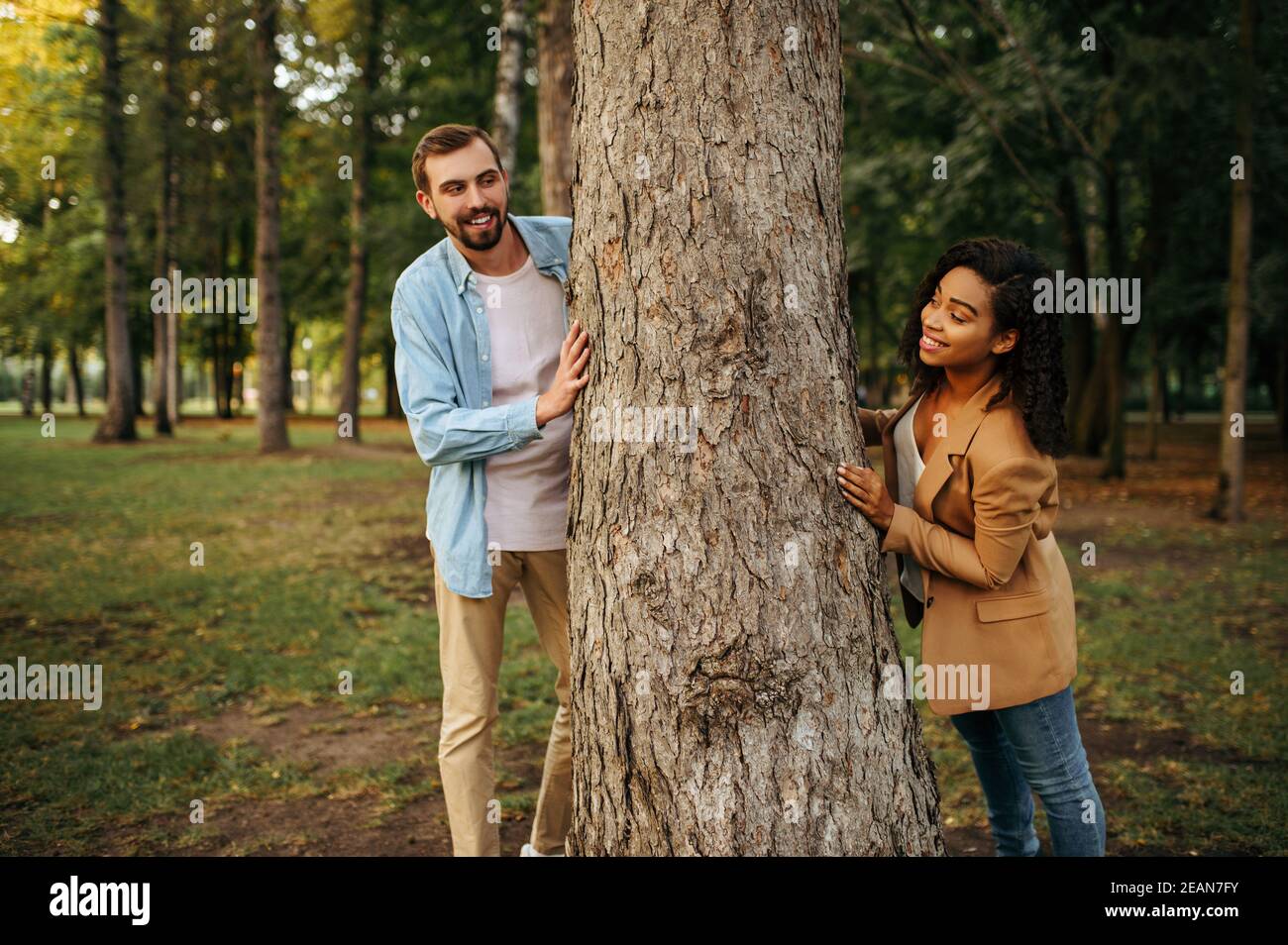 Love couple poses at the big tree in park Stock Photo - Alamy