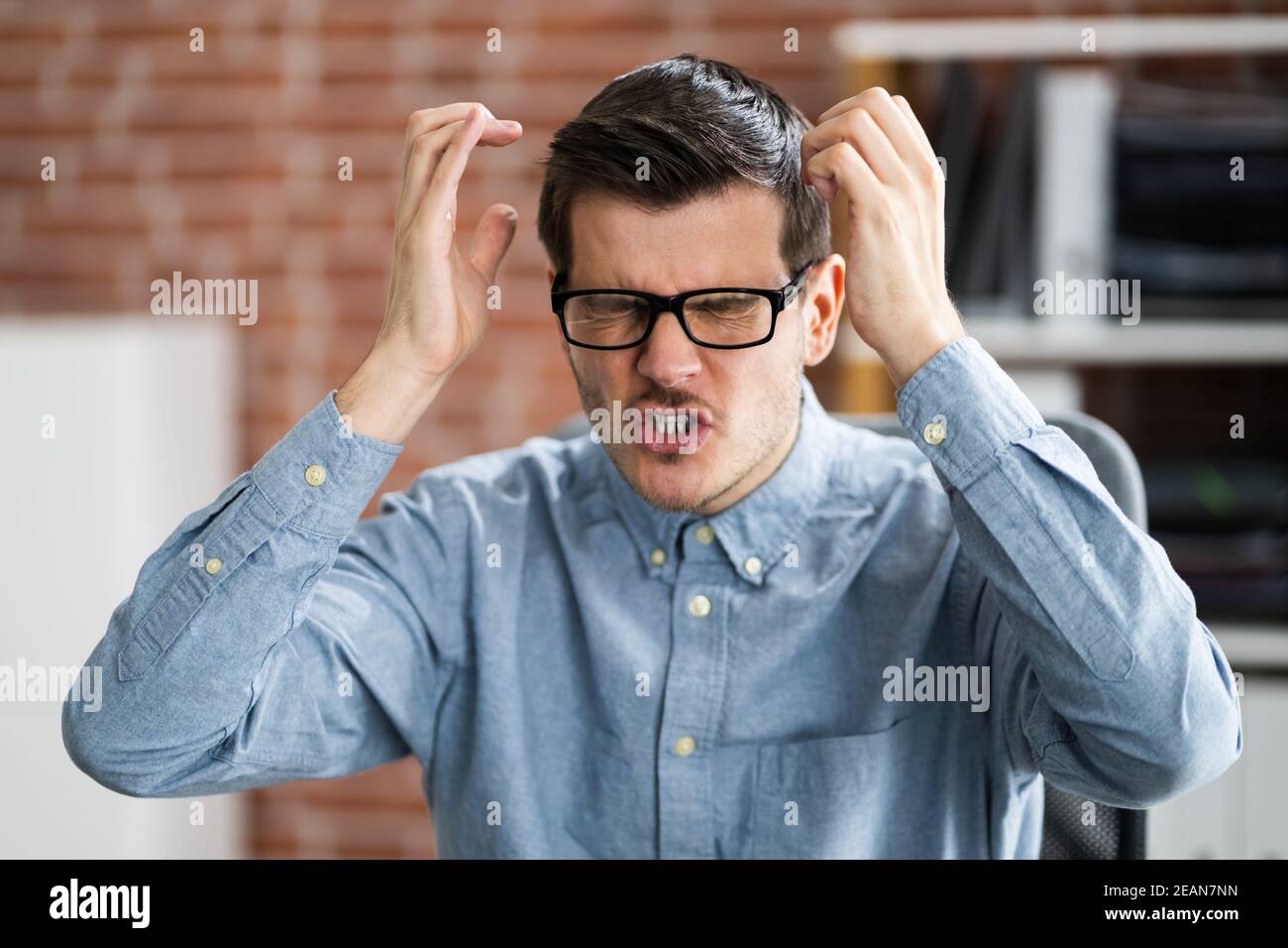 Workplace Quarrel. Angry Looking Man Stock Photo
