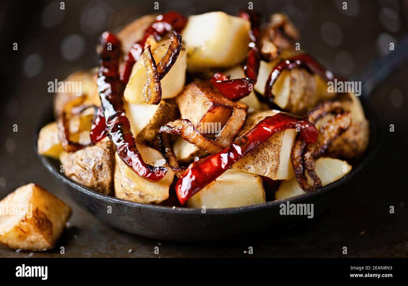 pan of spanish fried potatoes with capsicum and onions Stock Photo