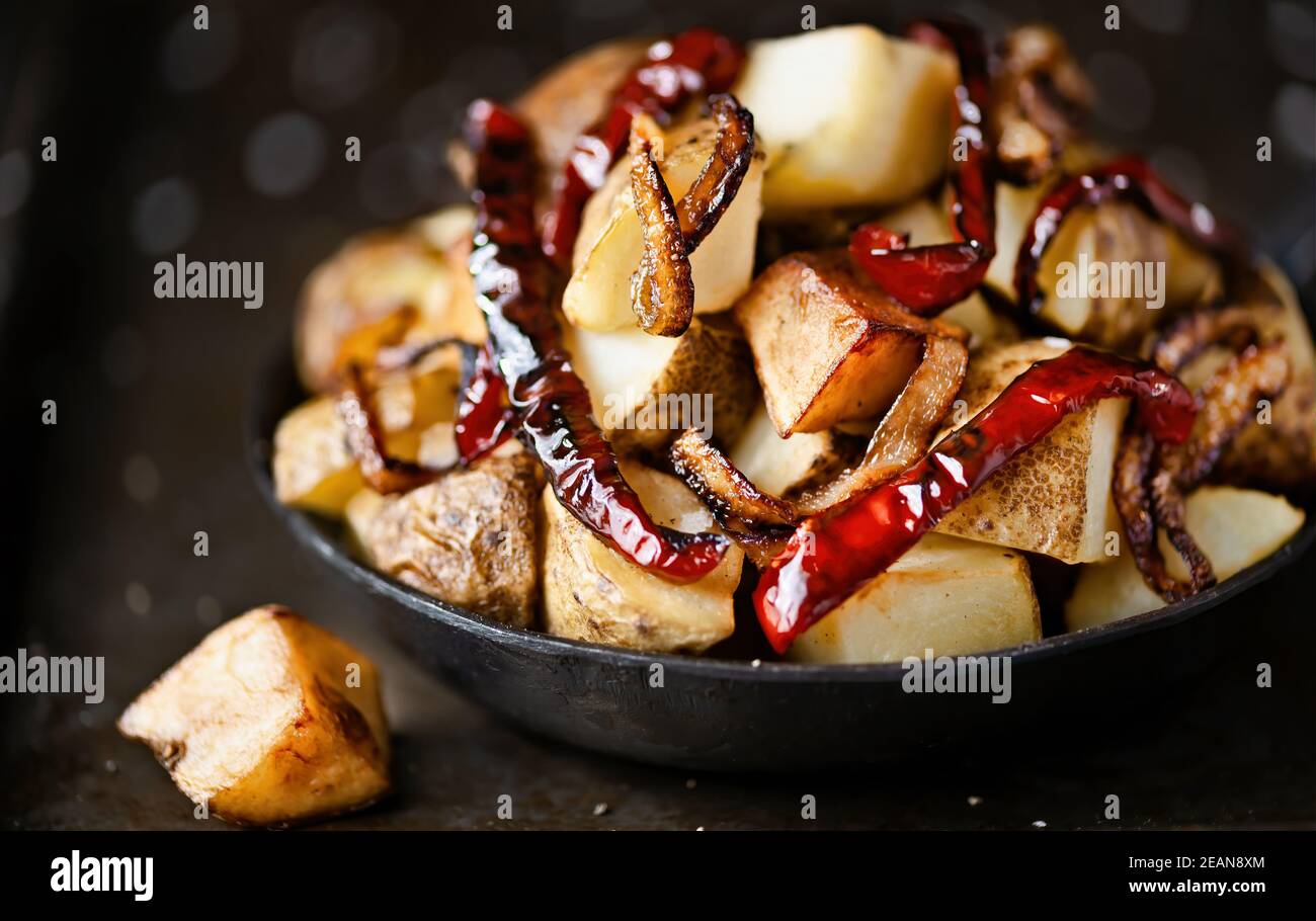 pan of spanish fried potatoes with capsicum and onions Stock Photo