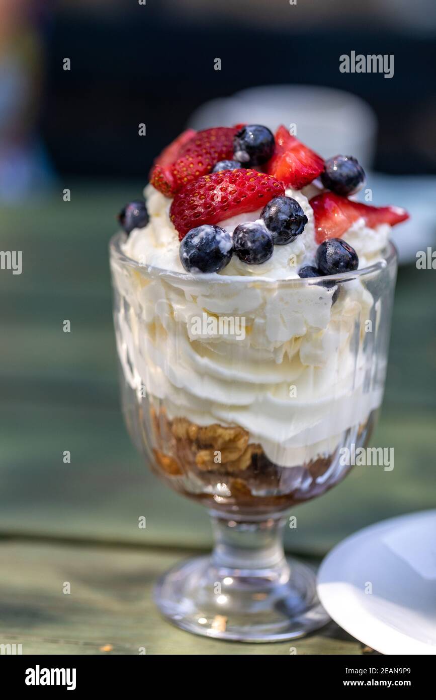 Sweet dessert - meringue with strawberries and blueberries Stock Photo