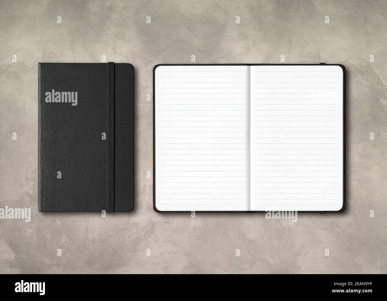 Black closed and open lined notebooks on concrete background Stock Photo