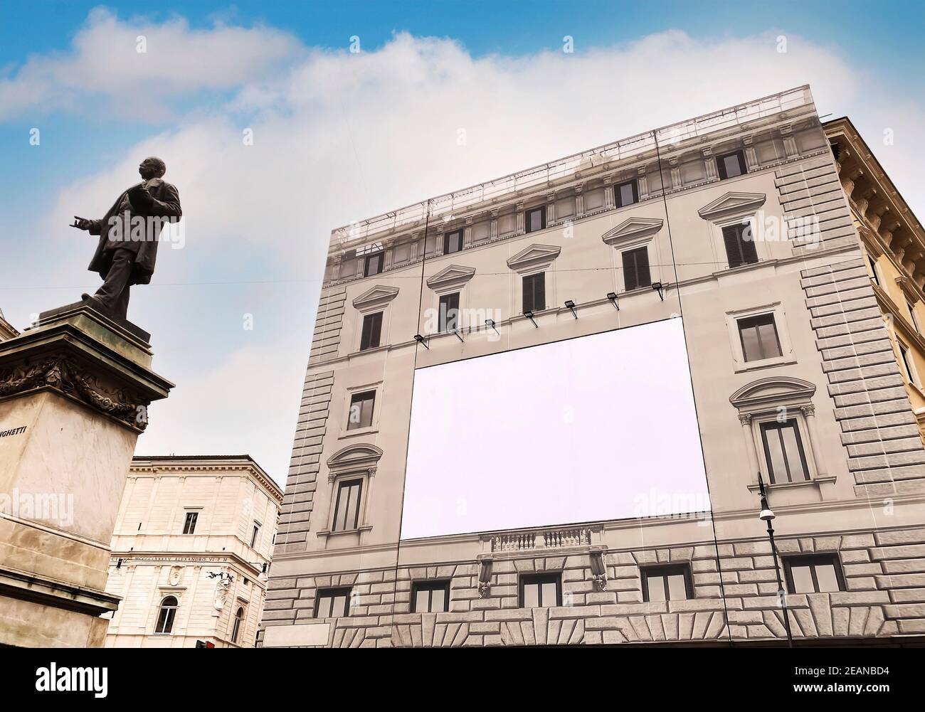 Blank advertising billboard on the scaffolding of the facade of an ancient building under restoration Stock Photo