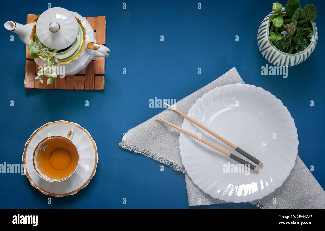 Empty white plate, chopsticks and herbal tea Stock Photo