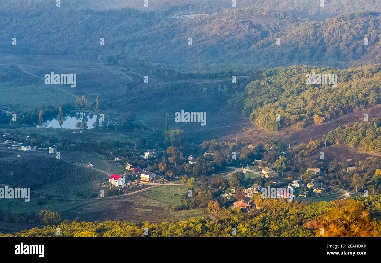 village in a mountain valley. A lake near a village in the valley Stock