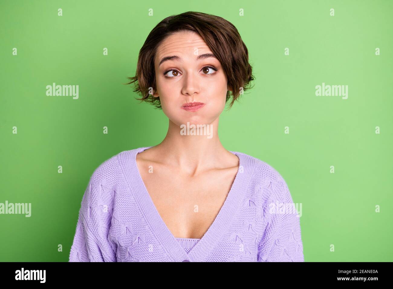 Photo of carefree playful person squint eyes holding breath wear violet isolated on green color background Stock Photo