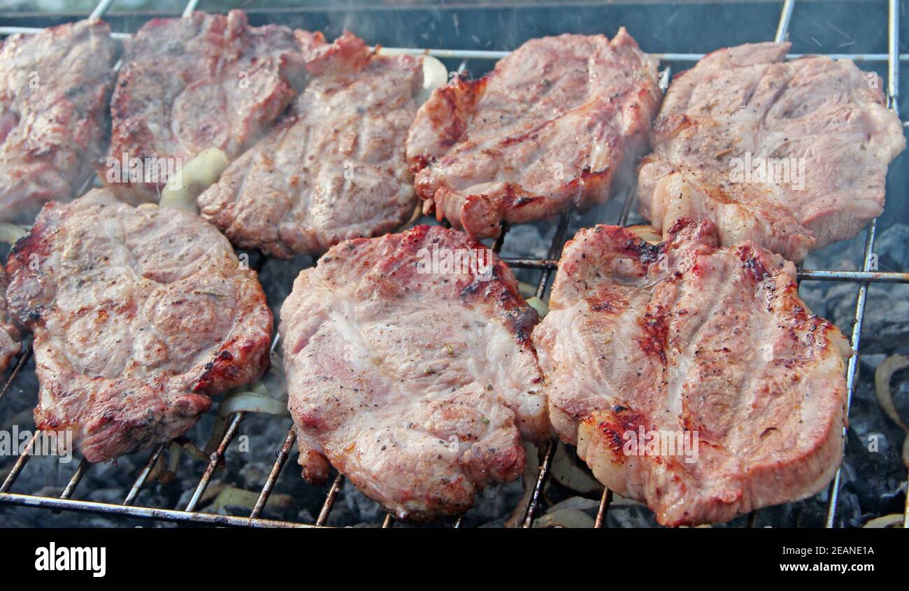 Steak on barbecue. Preparation appetizing pork outside Stock Photo