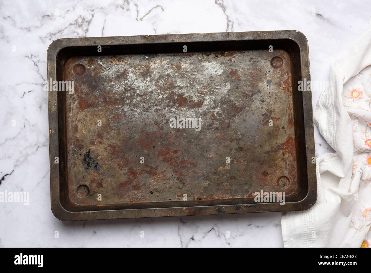 empty metal rectangular baking sheet on a white table Stock Photo