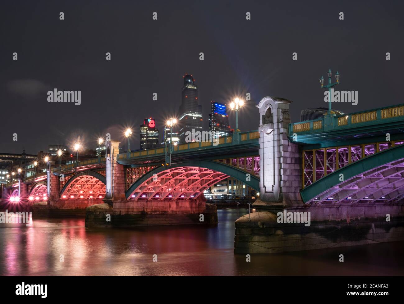 Southwark Bridge at night with illuminated buildings of the City of London financial district, Southwark, London, England, United Kingdom, Europe Stock Photo