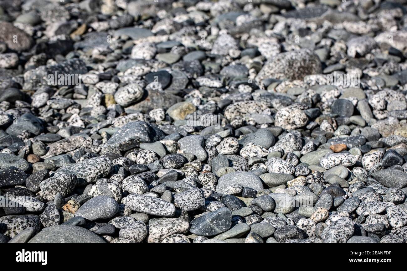 Grey Pebbles on the beach on ocean. Selective focus Stock Photo